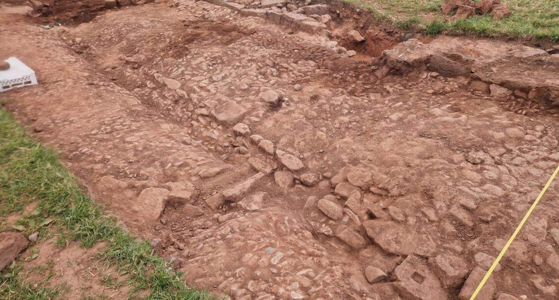 Stone walls and a “cobbled courtyard” were discovered just below the grassy surface.