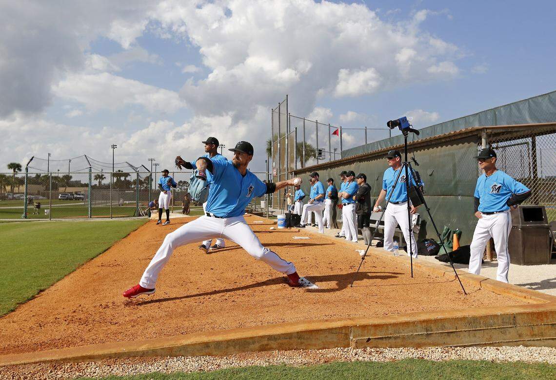Miami Marlins pitcher Caleb Smith (31) pitches as Marlins manager Don Mattingly (8) looks during the first full-squad spring training workout on Monday, February 18, 2019 in Jupiter, FL.