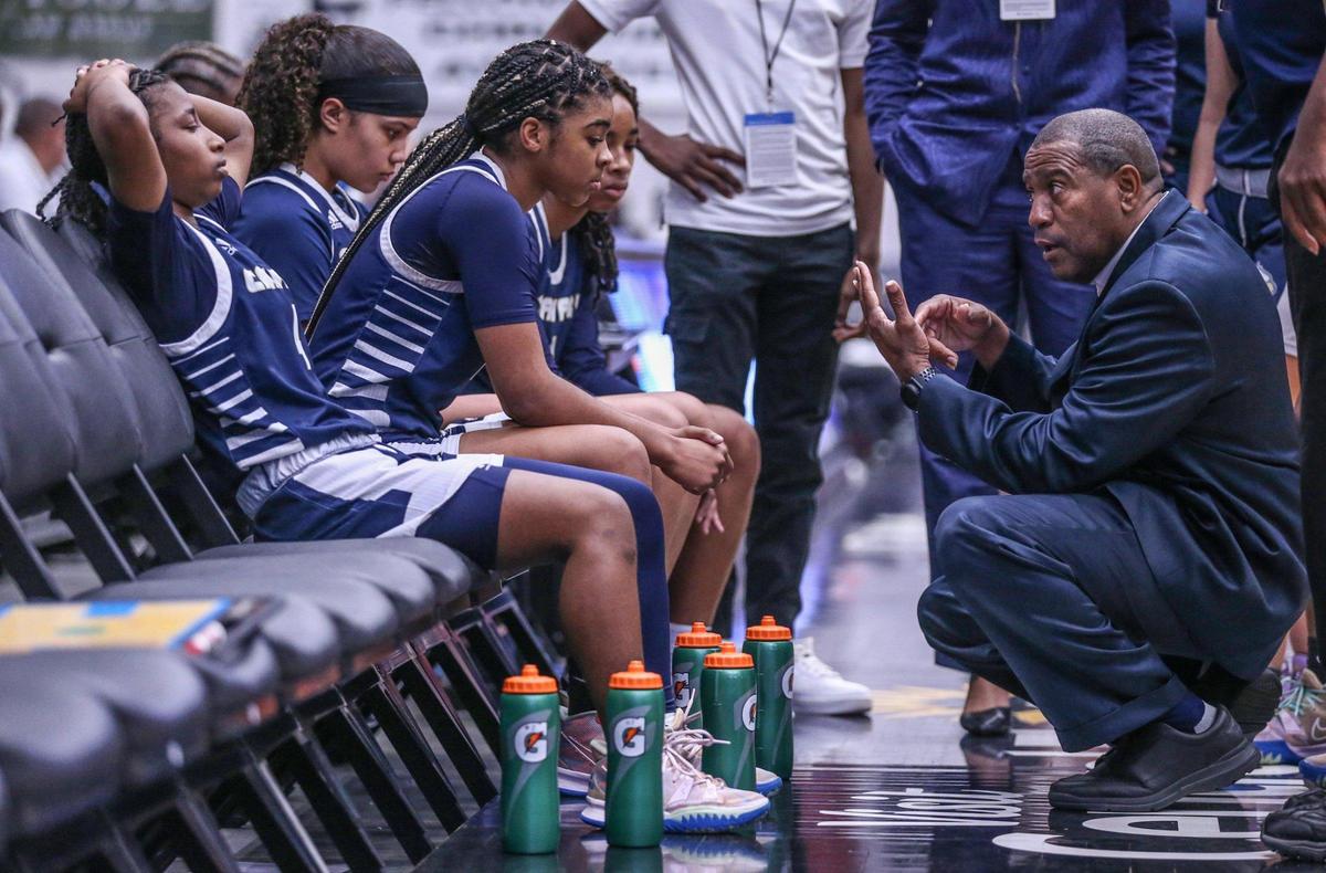 Calvary Christian Academy head coach George Adams talks to players during a time out as they trail against Lake Highland Prep in the Class 4A girls basketball state championship at the RP Funding Center in Lakeland on Saturday, February 26, 2022.