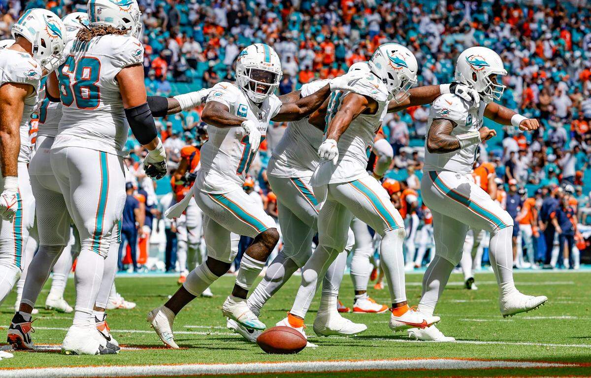 Miami Dolphins quarterback Tua Tagovailoa (1) leads the team as they dance to the Miami Dolphins fight song during the second quarter of a game against the Denver Broncos at Hard Rock Stadium in Miami Gardens on Sunday, September 24, 2023.