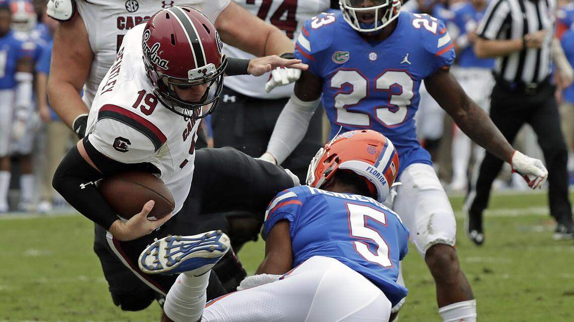 Florida defensive back CJ Henderson (5) stops South Carolina quarterback Jake Bentley (19) Saturday, Nov. 10, 2018, in Gainesville.