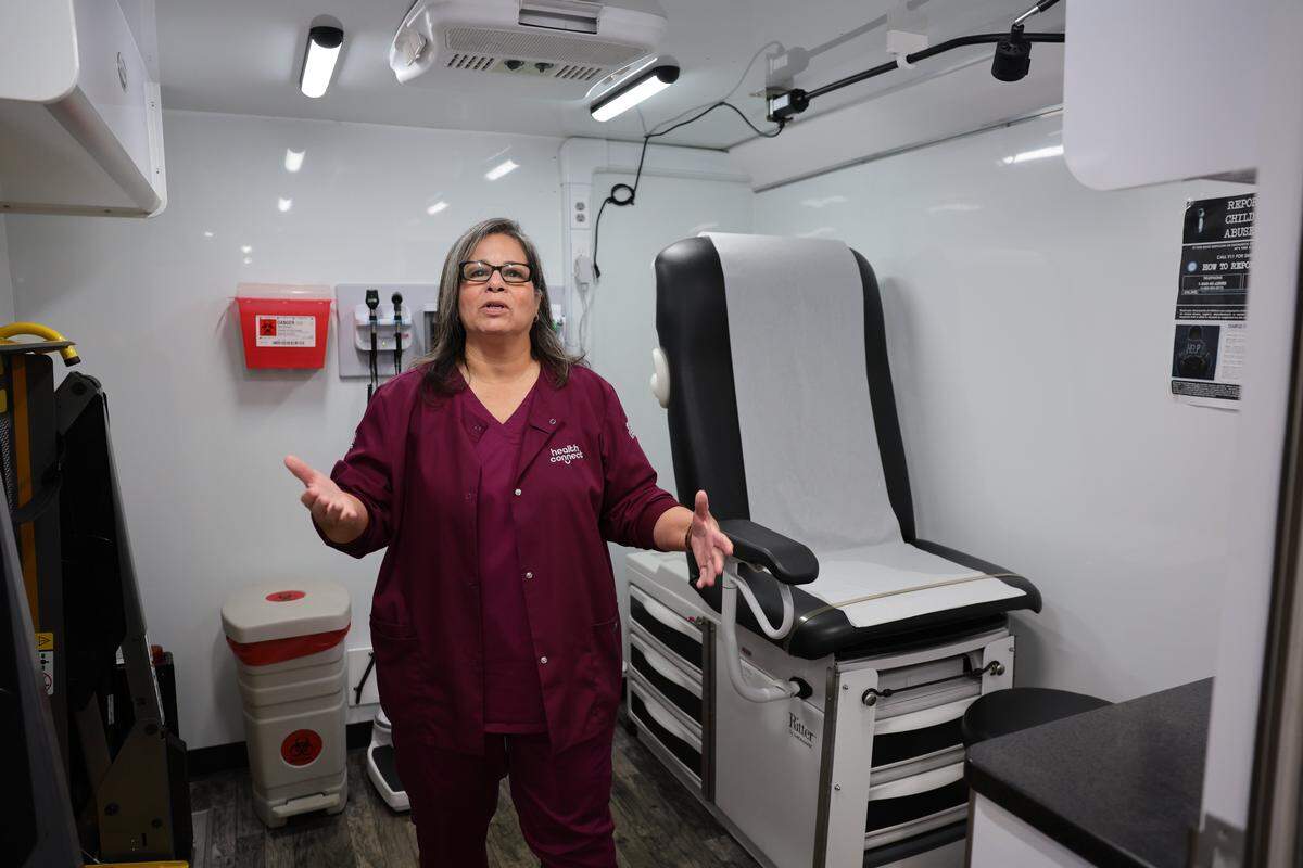 Luz Roza, a patient care technician with Community Health of South Florida, shows the inside of a mobile health unit parked at Spanish Lake Elementary School in Hialeah, Florida, Tuesday, Jan. 13, 2026. 