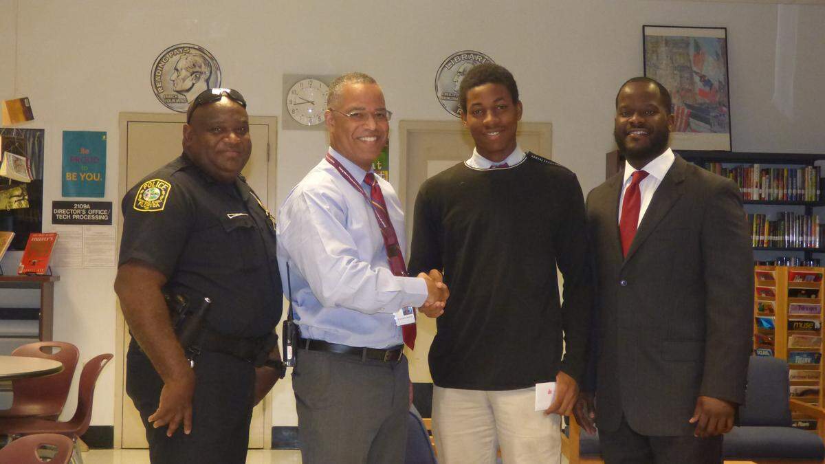 David Jenkins, third from left, of the Young Men’s Preparatory Academy recently received several $100 gift cards as part of the Miami Herald’s Wish Book Program. The gift cards were delivered to David by Officer Samuels of the Miami-Dade Schools Police Department, Principal Pierre Edouard, and Matthew Tisdol representing Miami-Dade School Board Member Dorothy Bendross-Mindingall.