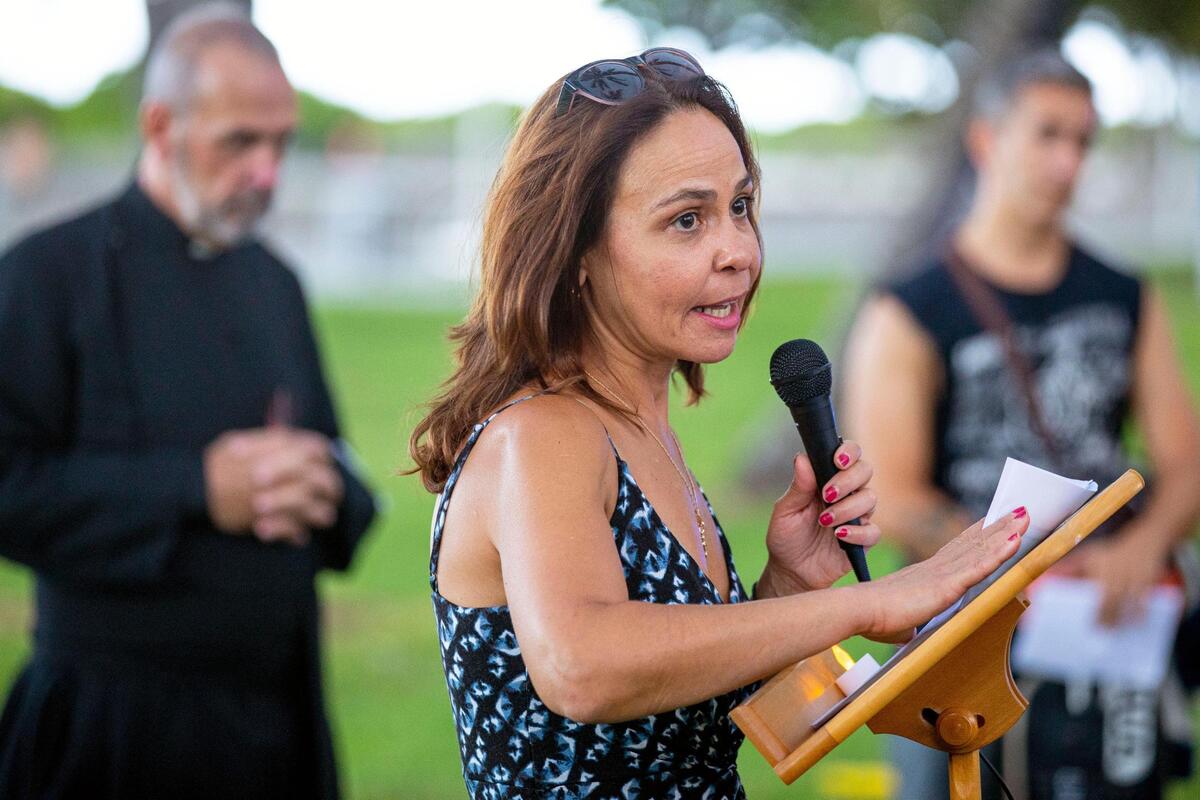 Community activist and Ocean Drive resident Irene Bigger, speaks to a crowd during a vigil Tuesday to honor the life of Dustin Wakefield, at Lummus Park near the restaurant where Wakefield, 21, a tourist from Colorado, was fatally shot.
