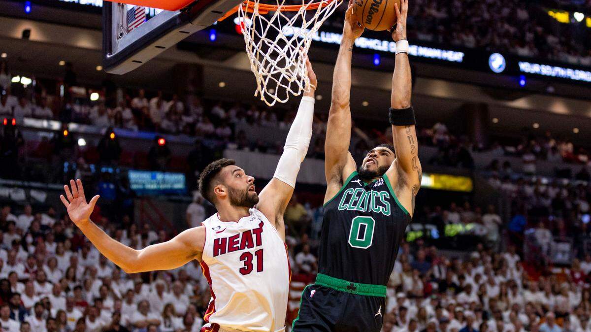 Boston Celtics forward Jayson Tatum (0) dunks on Miami Heat forward Max Strus (31) during the first quarter of Game 3 of the NBA Eastern Conference Finals series at Kaseya Center in Miami, Florida, on May 21, 2023.