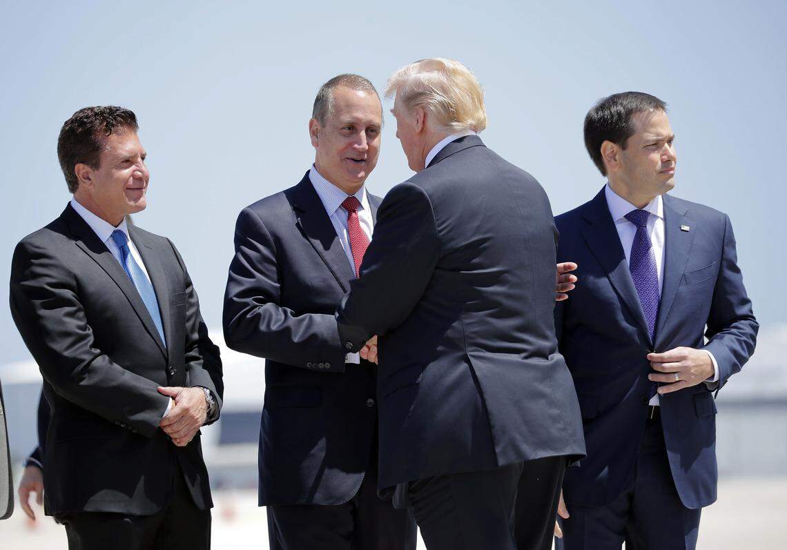 In this April 16, 2018, photo, President Donald Trump is greeted by, from left, Hialeah Mayor Carlos Hernandez, Rep. Mario Diaz-Balart and Sen. Marco Rubio on the tarmac upon Trump’s arrival at Miami International Airport.