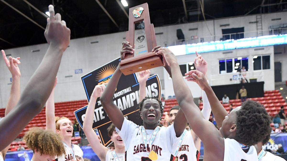 Sagemont’s Patrick Liburd (5) hoists the trophy as they celebrate their win over Orlando Christian Prep in the Class 2A final during the Florida High School State Championships at the RP Funding Center in Lakeland, Fl on Thursday February 29, 2024. Sagemont defeated Orlando Christian Prep 50-47.