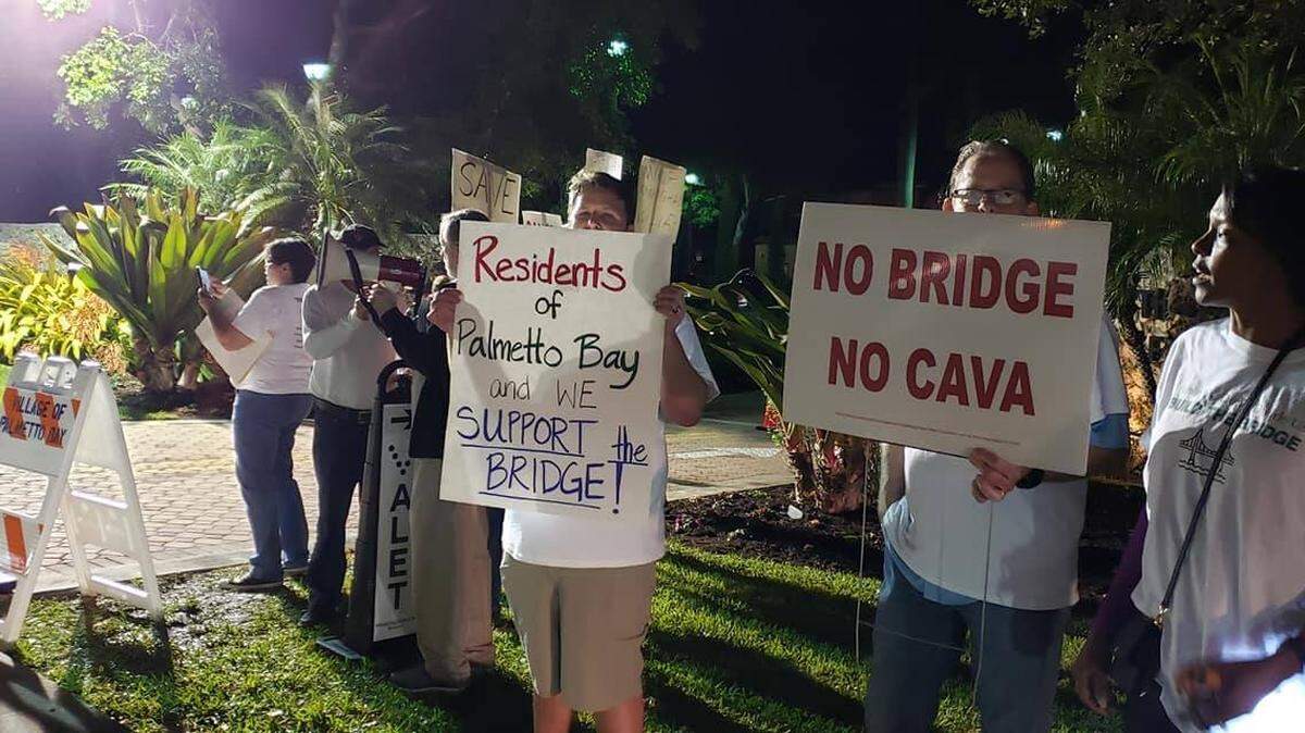 Miami-Dade County’s plan for a bridge over a canal on Southwest 87th Avenue has divided residents on both sides of the project. Palmetto Bay hopes to block the project, which recently began work.