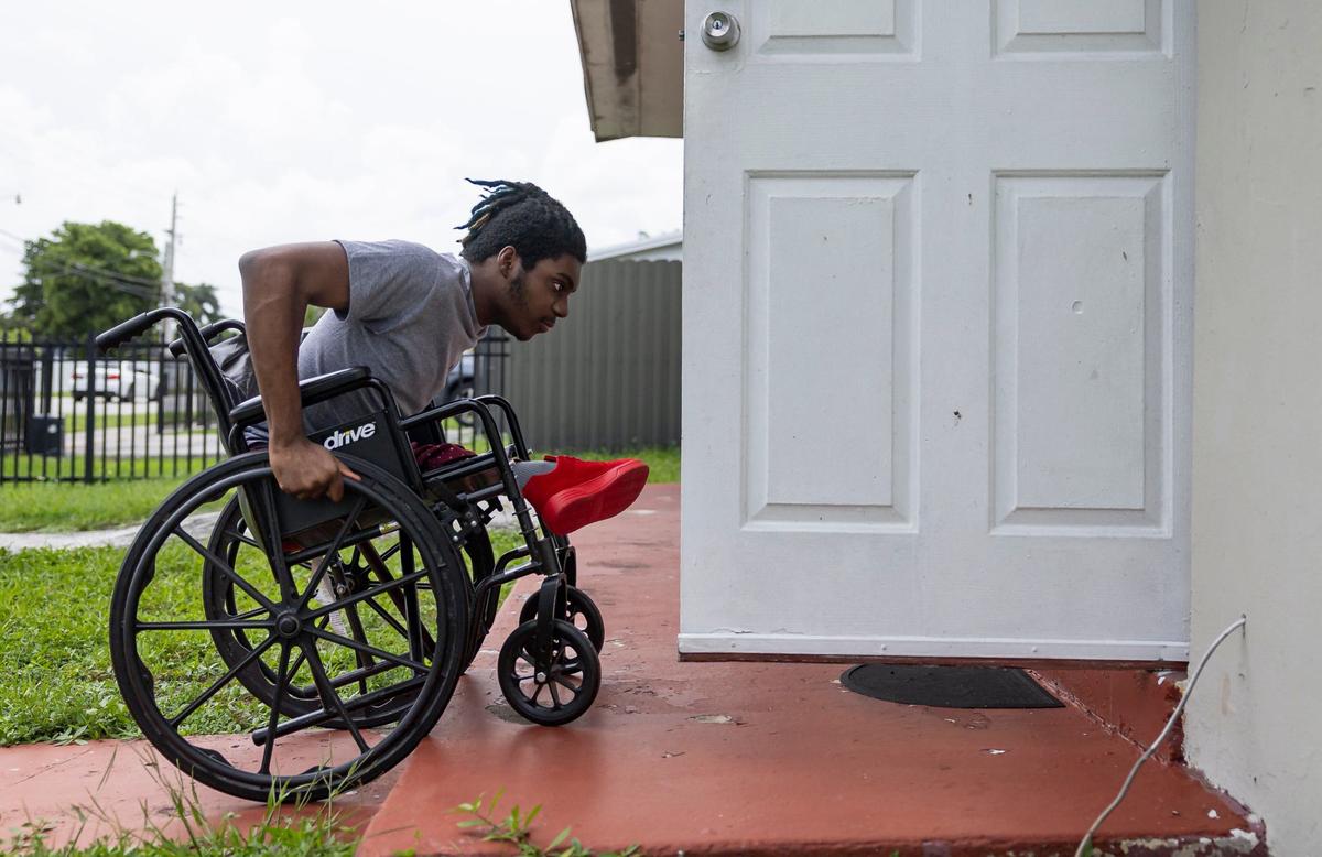 Elijah Solomon, 19, makes his way inside his home in Miami Gardens. Because of adaptive services provided to him by Miami-Dade schools’ revamped driver’s education program, he was able to get his license.