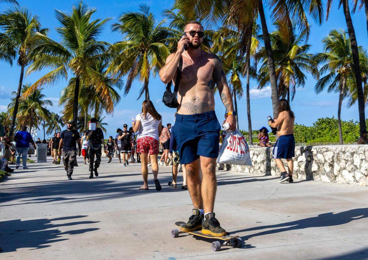 A man rolls down the beach walk during Memorial Day weekend at Miami Beach, Florida, on Sunday, May 28, 2023.