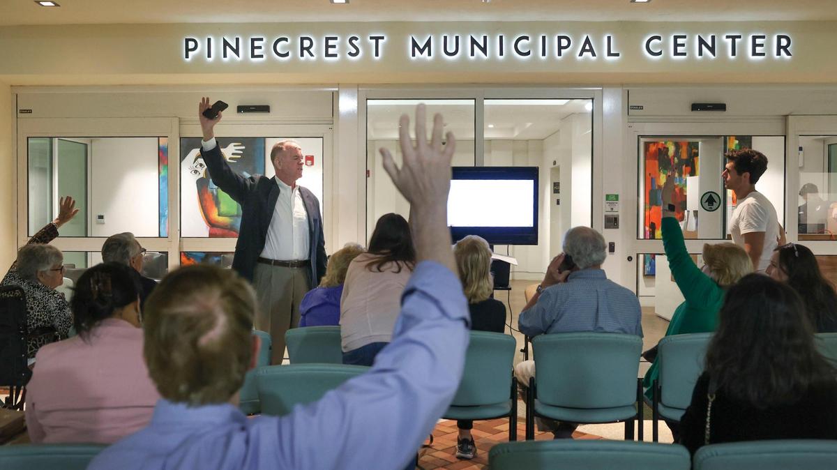 People in the overflow area raise concerns during a Pinecrest Village Council meeting while the television experiences technical difficulties on Tuesday, Jan. 10, 2023, in Pinecrest.