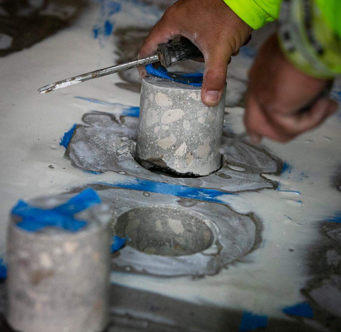 A worker removes a core sample of the concrete at Champlain Towers North in Surfside on July 13, 2021.