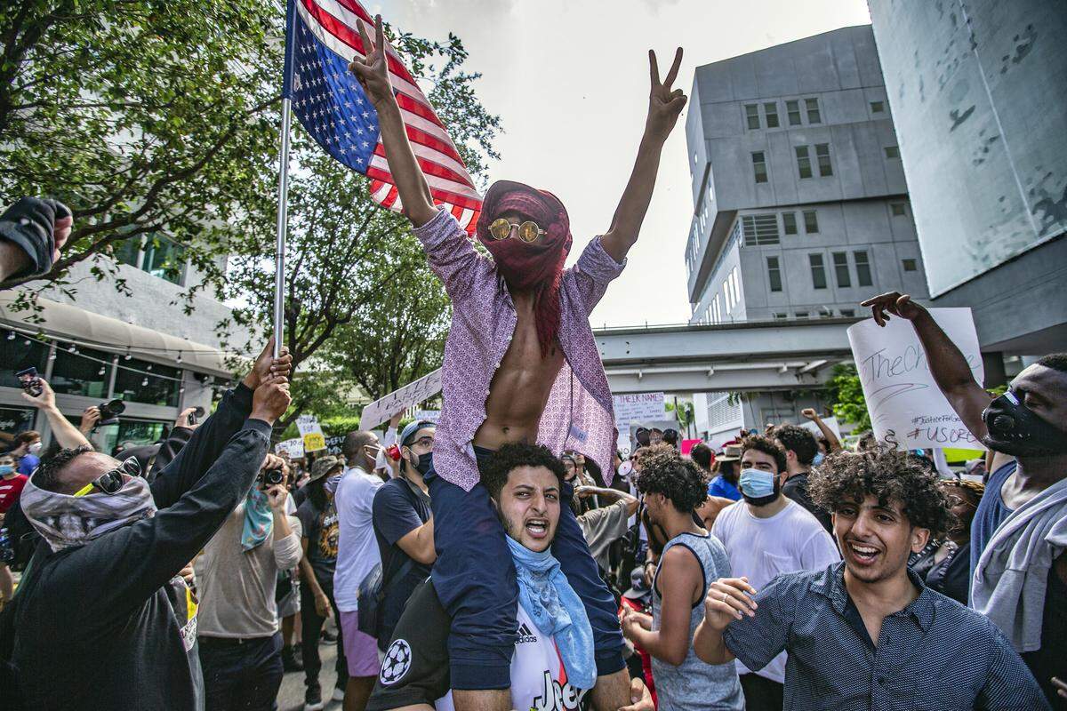 Hundreds take part in a protest in downtown Miami over the death of George Floyd.