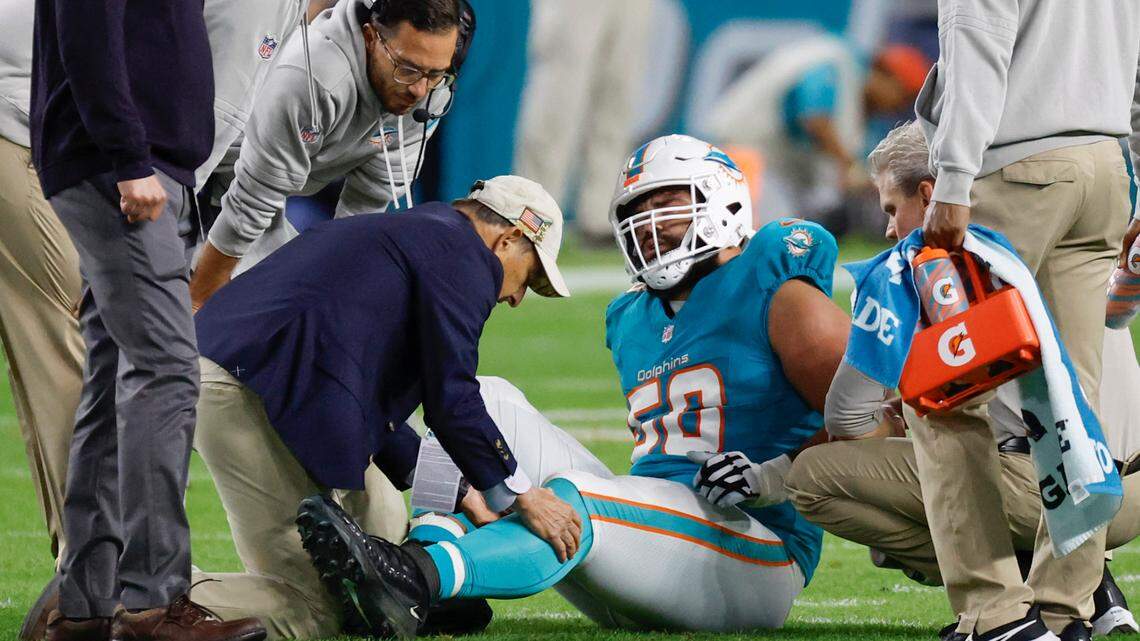 Miami Dolphins guard Connor Williams (58) is treated after being treated during the game against the Tennessee Titans in the first half at Hard Rock Stadium in Miami Gardens, Florida on Monday, December 11, 2023. 
