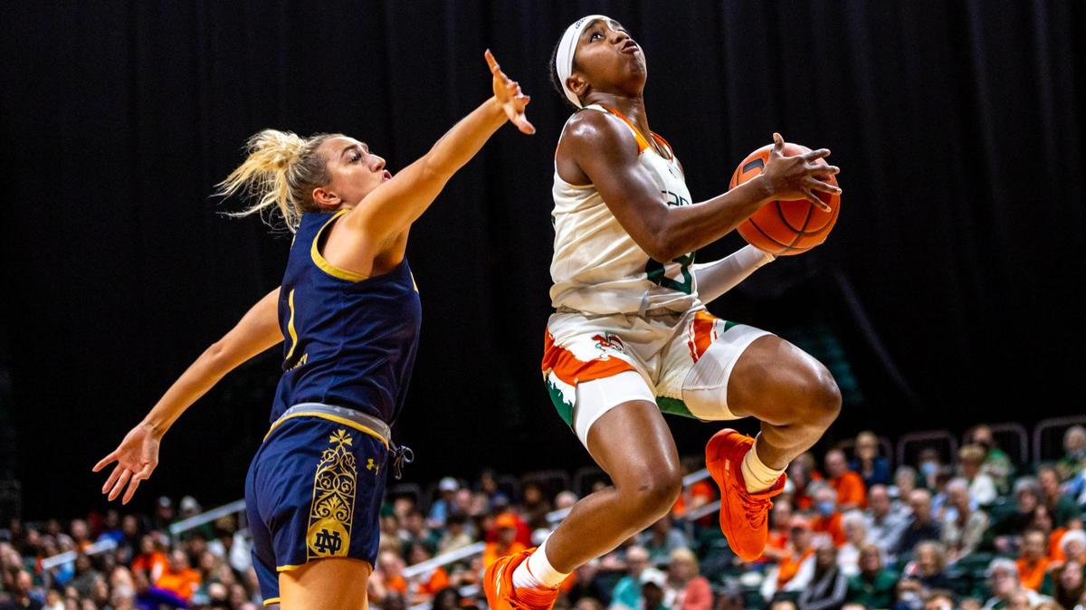 Hurricanes guard Lashae Dwyer, who scored 10 points, floats past Notre Dame guard Dara Mabrey to the basket during the first half at the Watsco Center on Thursday night