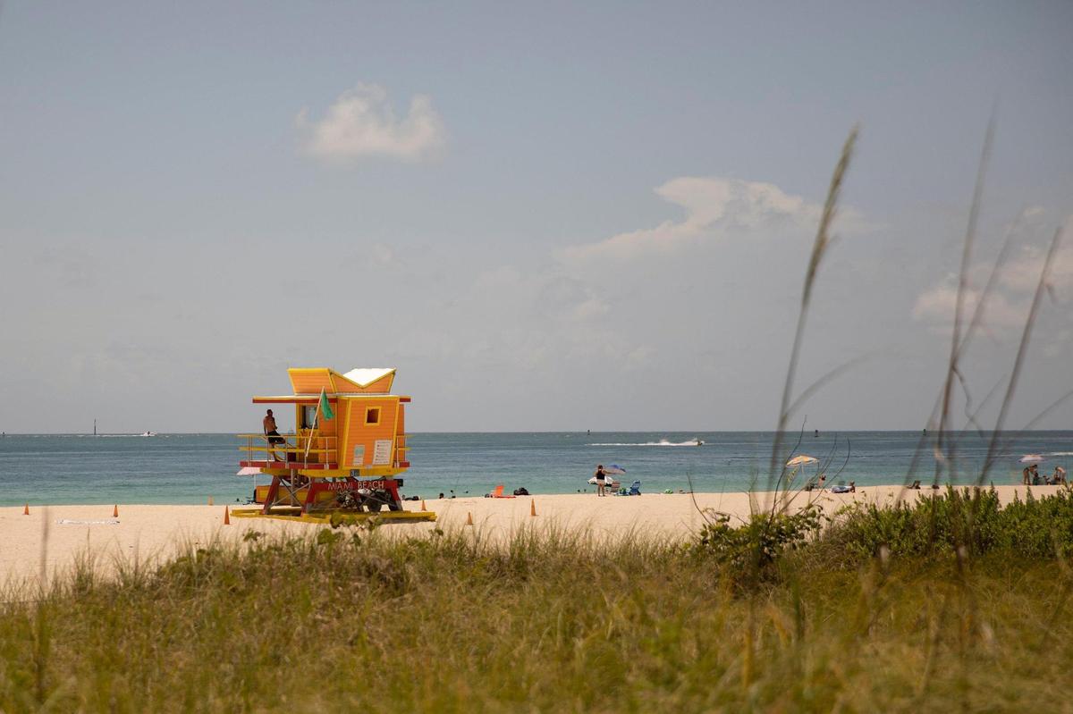 A lifeguard watches the waters in Miami Beach in this file photo from Monday, June 13, 2022. A month later, the heat index is expected to hit 107 on July 13, and remain in the triple digits into the weekend, according to the National Weather Service.