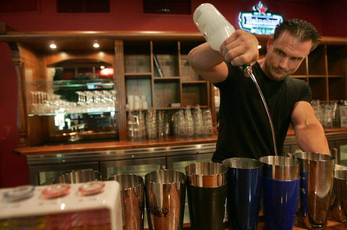 In 2009, bartender Rodney Brewer pours inside Crazy Pianos bar and restaurant inside CocoWalk in Coconut Grove.