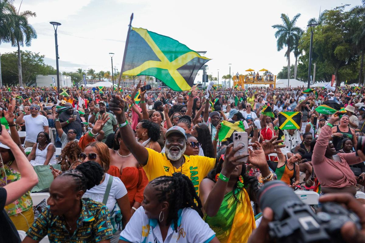 A man waving a Jamaican flag from the audience reacts to the music during the 19th annual Best of the Best International Music Festival at Bayfront Park in downtown Miami, Sunday, May 25, 2025. The event attracted music fans from across the Caribbean region.