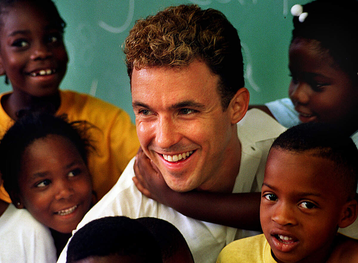 On June 8, 1995, Mike Carricarte, Jr., led a fundraising drive resulting in $150,000 in private donations to build new classrooms at St. Francis Xavier Catholic School in Overtown. He's shown with some of the kindergarten kids at the school, that was at 1698 NW Fourth Ave. He was inspired by the example his father, Mike Carricarte, set.