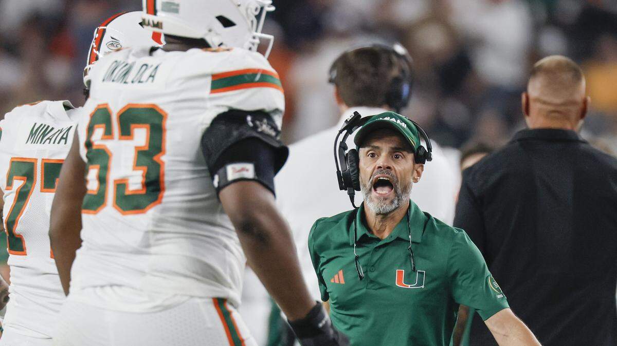 Miami Hurricanes offensive line coach Alex Mirabal celebrates with layers during the first half of a College Football Playoff semifinal against the Mississippi Rebels in the Fiesta Bowl at State Farm Stadium on Thursday, January 8, 2026 in Glendale, Arizona.