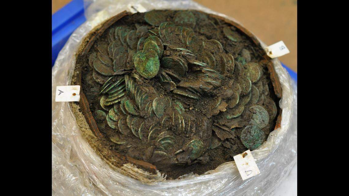 The coins were layered in a large ceramic vessel, officials said.