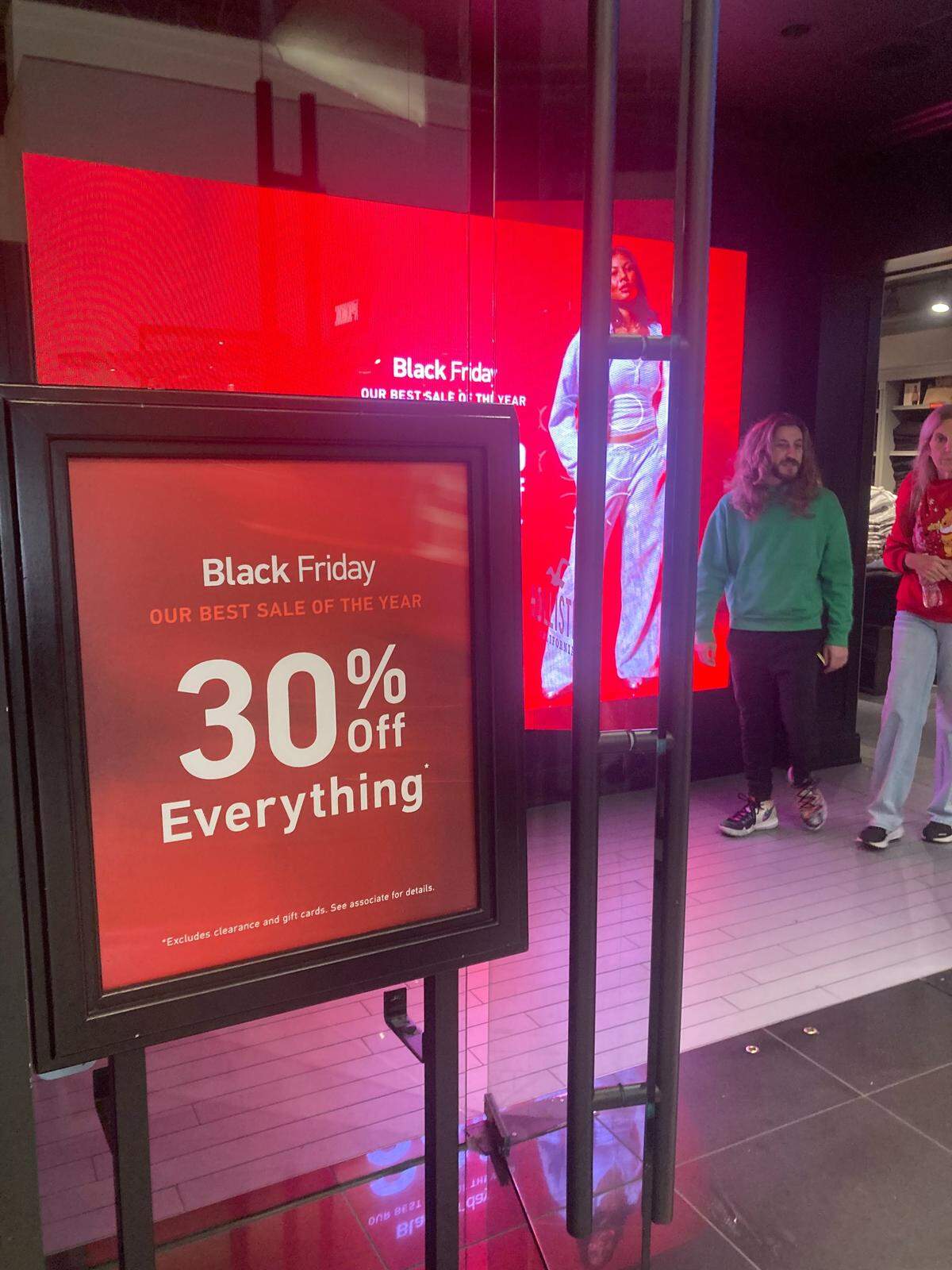 A Black Friday discount sign in front of Hollister at Sawgrass Mills mall.