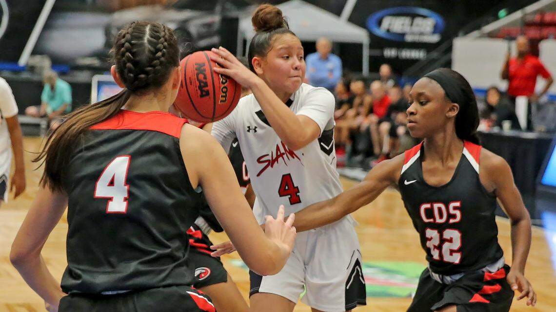 SLAM Marta Franco (4) looks to pass the ball while being guarded by the Carrollwood Day defense in the 4A Semi-Finals Girl’s State Basketball Championships at the RP Funding Center in Lakeland, Florida, Wednesday, February, 27, 2019.