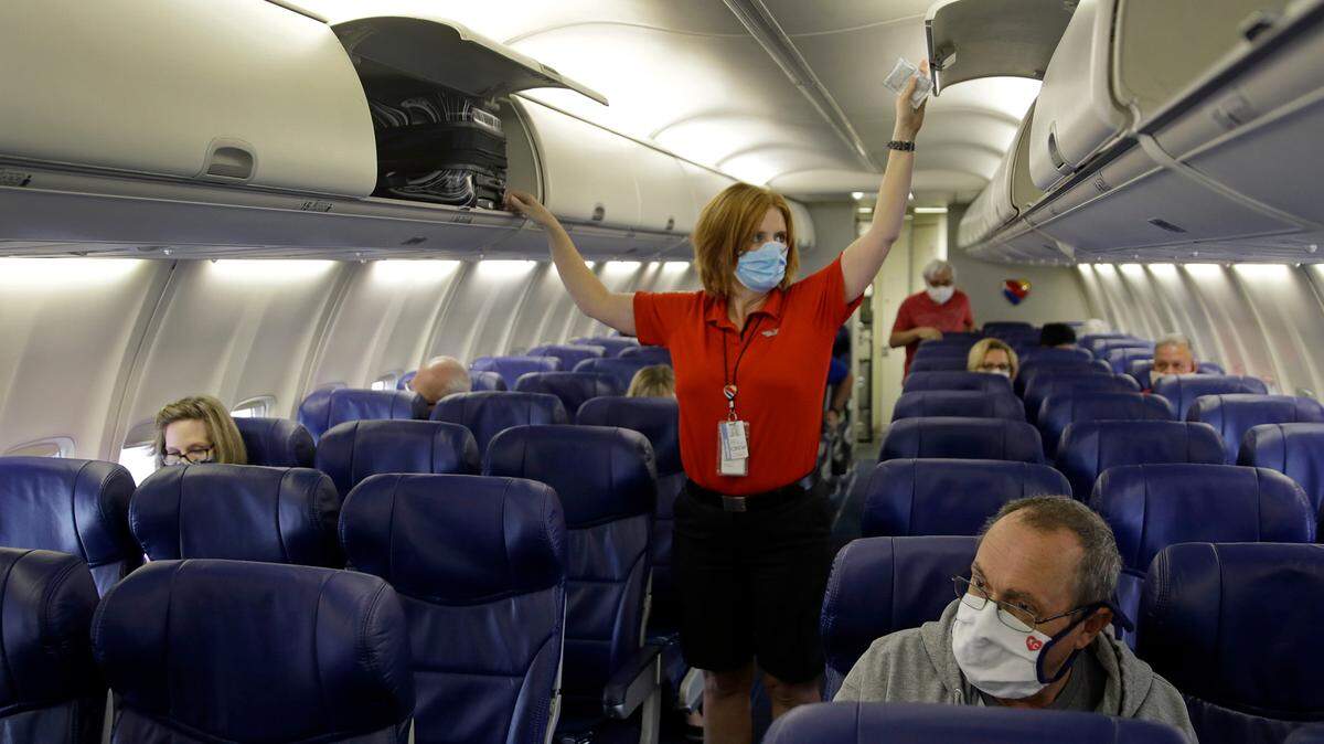 In 2020, a Southwest Airlines flight attendant prepares a plane bound for Orlando for takeoff at Kansas City International airport in Kansas City, Missouri.