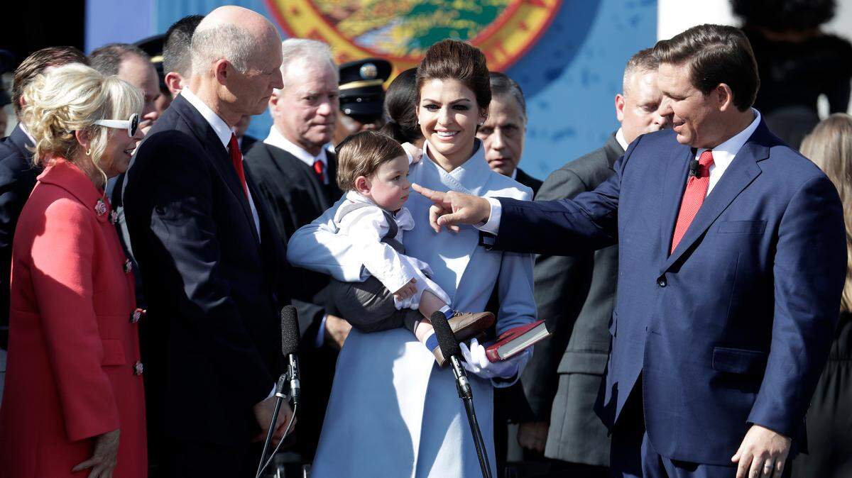 Ron DeSantis, right, stands with his son, Mason, and wife, Casey, second from right, before being sworn in as Florida governor on Tuesday, Jan. 8, 2019, in Tallahassee. Republicans will begin their third decade dominating the state’s Capitol. At left is outgoing Gov. Rick Scott and his wife, Ann.
