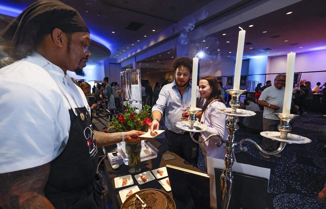 Maple & Ash Saus Chef Chadd Hood serves up Wagyu Beef Carpaccio to Michael Dugas and Kathleen Ditton as the Fontainebleau Miami Beach presents Wine Spectator's Best of the Best with 60 of the nation’s most acclaimed chefs and more than 65 of the world’s premier wineries at the resort hotel on Friday, February 20, 2026.