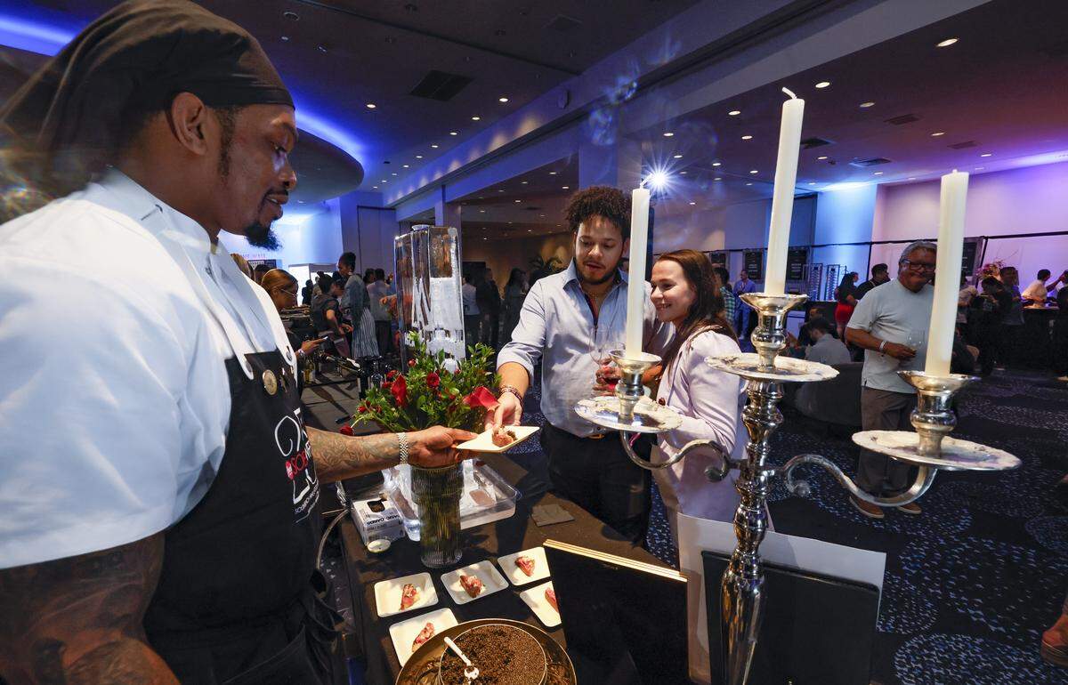 Maple & Ash Saus Chef Chadd Hood serves up Wagyu Beef Carpaccio to Michael Dugas and Kathleen Ditton as the Fontainebleau Miami Beach presents Wine Spectator's Best of the Best with 60 of the nation’s most acclaimed chefs and more than 65 of the world’s premier wineries at the resort hotel on Friday, February 20, 2026.