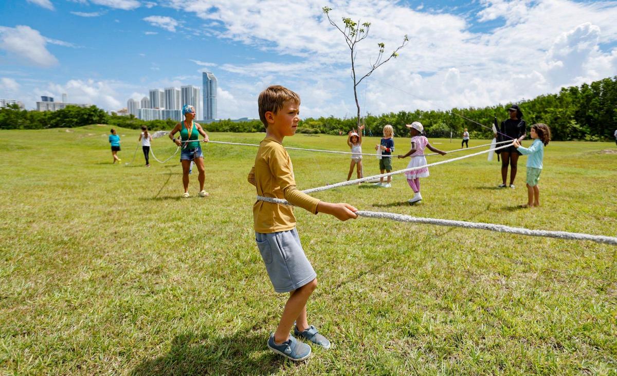 Henry Cedroni, 6, helps to mark the site with rope of a proposed pickleball court at Oleta Park. He joined protesters with Keep Florida State Parks Wild-Defend Oleta State Park against the Florida Department of Environmental Protection’s plan to add pickleball courts, cabins, and a disc golf course to Oleta River State Park in North Miami Beach, Florida on Tuesday, August 27, 2024.