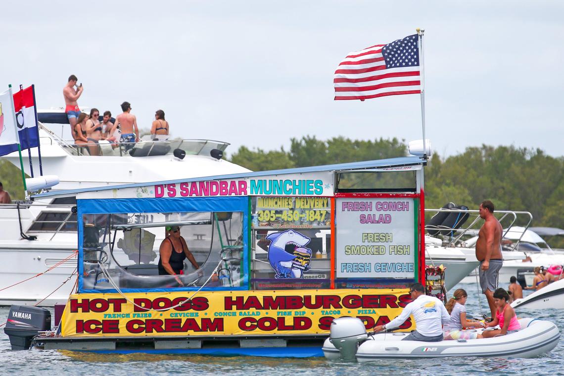 D’s Sandbar Munchies concession navigates by the Bill Bird Marina at Haulover Park during the first day of Memorial Day Weekend on Saturday, May, 23, 2020. The U.S. Army Corps of Engineers wants to dredge the Haulover sandbar and use the sand to replenish the beach off Bal Harbour.