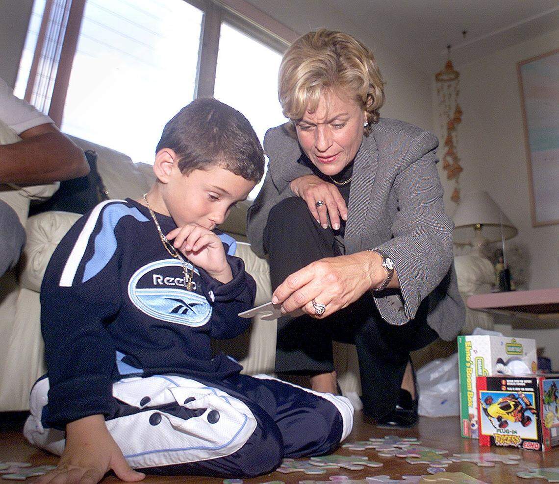 Congresswoman Ileana Ros-Lehtinen plays with Elian Gonzalez.