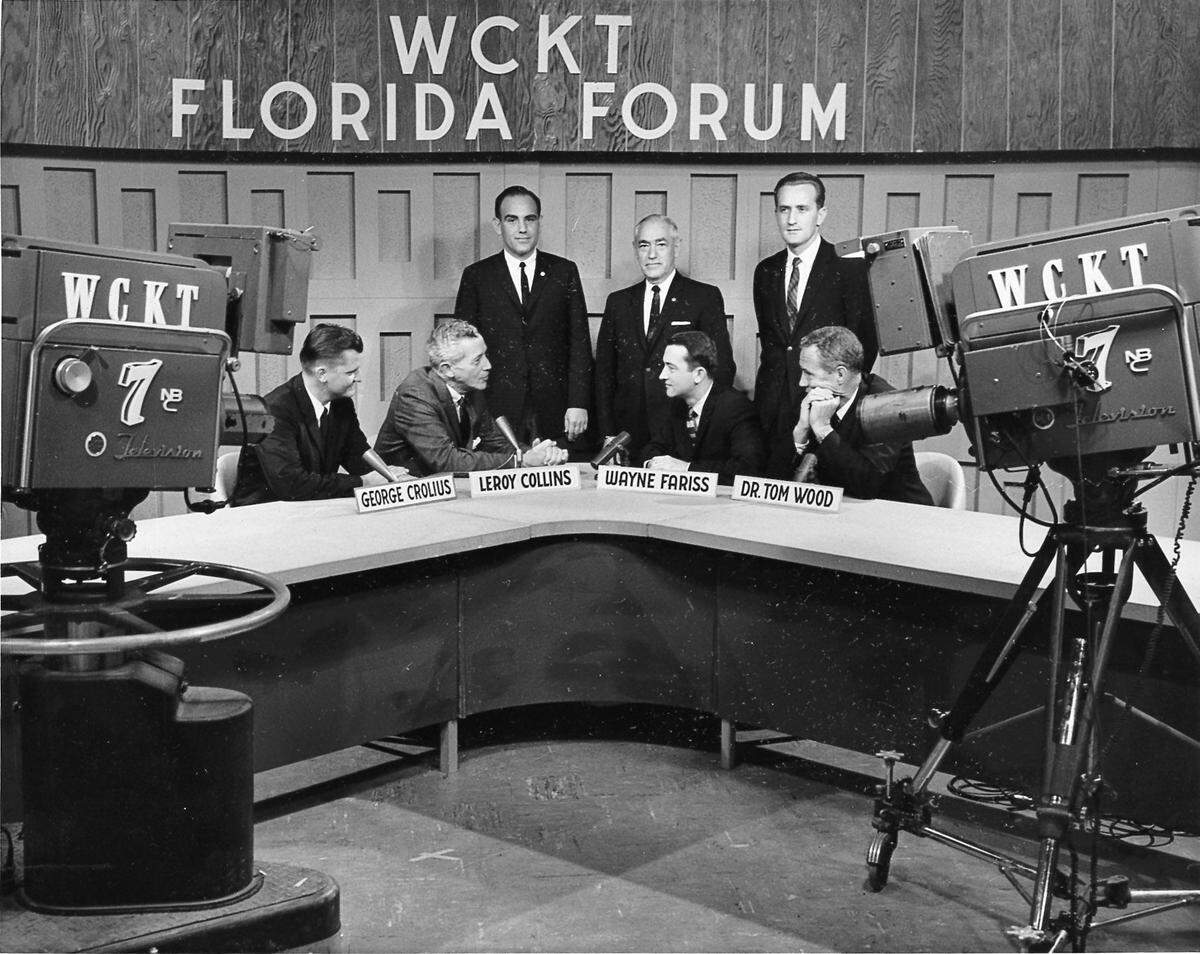 Channel 7’s Wayne Farris at the anchor desk with then-Florida Gov. Leroy Collins. Channel 7 owner Ed Ansin is standing at right.