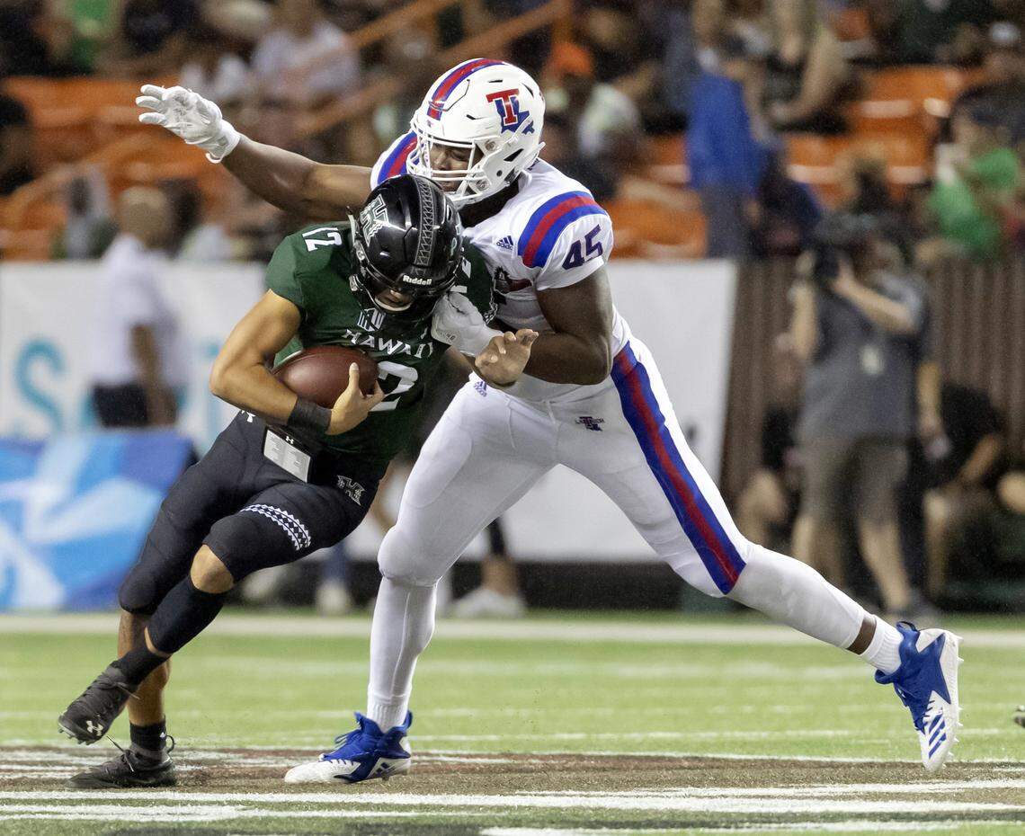 Louisiana Tech defensive end Jaylon Ferguson (45) sacks Hawaii quarterback Chevan Cordeiro (12) in the first half of the Hawaii Bowl NCAA college football game, in Honolulu. Louisiana Tech defensive end Jaylon Ferguson and Colorado State wide receiver Preston Williams have already completed their work in Indianapolis. They didn’t lift weights, didn’t get clocked in the 40-yard dash, didn’t even appear on the NFL telecast. Instead, they took medical tests and tried explaining to team officials why they couldn’t work out with everyone else at the league’s annual scouting combine.