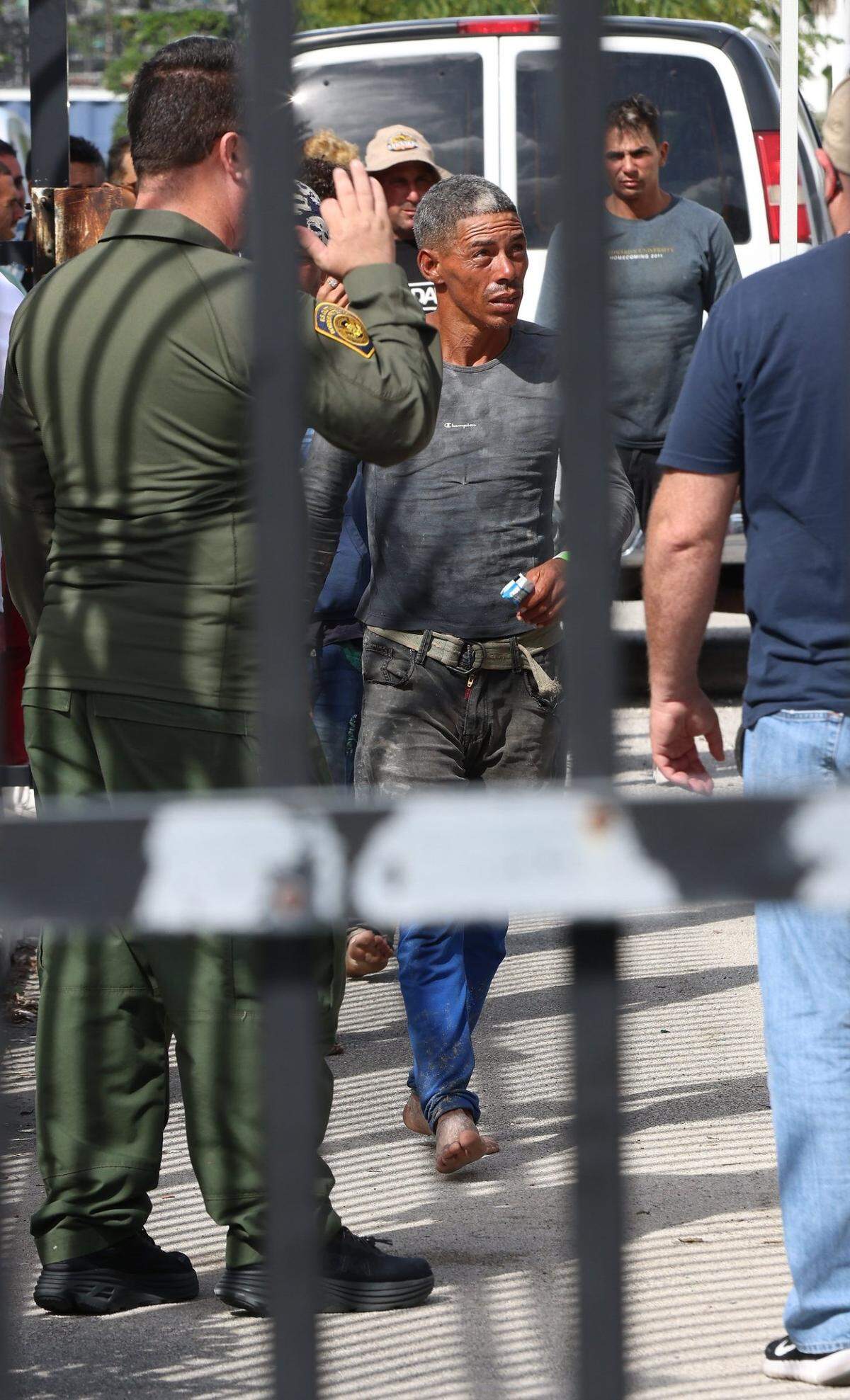 Cuban migrants exit the U.S. Border Patrol transport van as they are gathered to be processed. On Wednesday, Jan. 4, 2023, about 40 men, women and some small children were processed at the Border Patrol station in Marathon in the Florida Keys. They were among hundreds of people from Cuba, and one large group of over 100 men and women from Haiti, who’ve landed across the island chain since the end of last week.