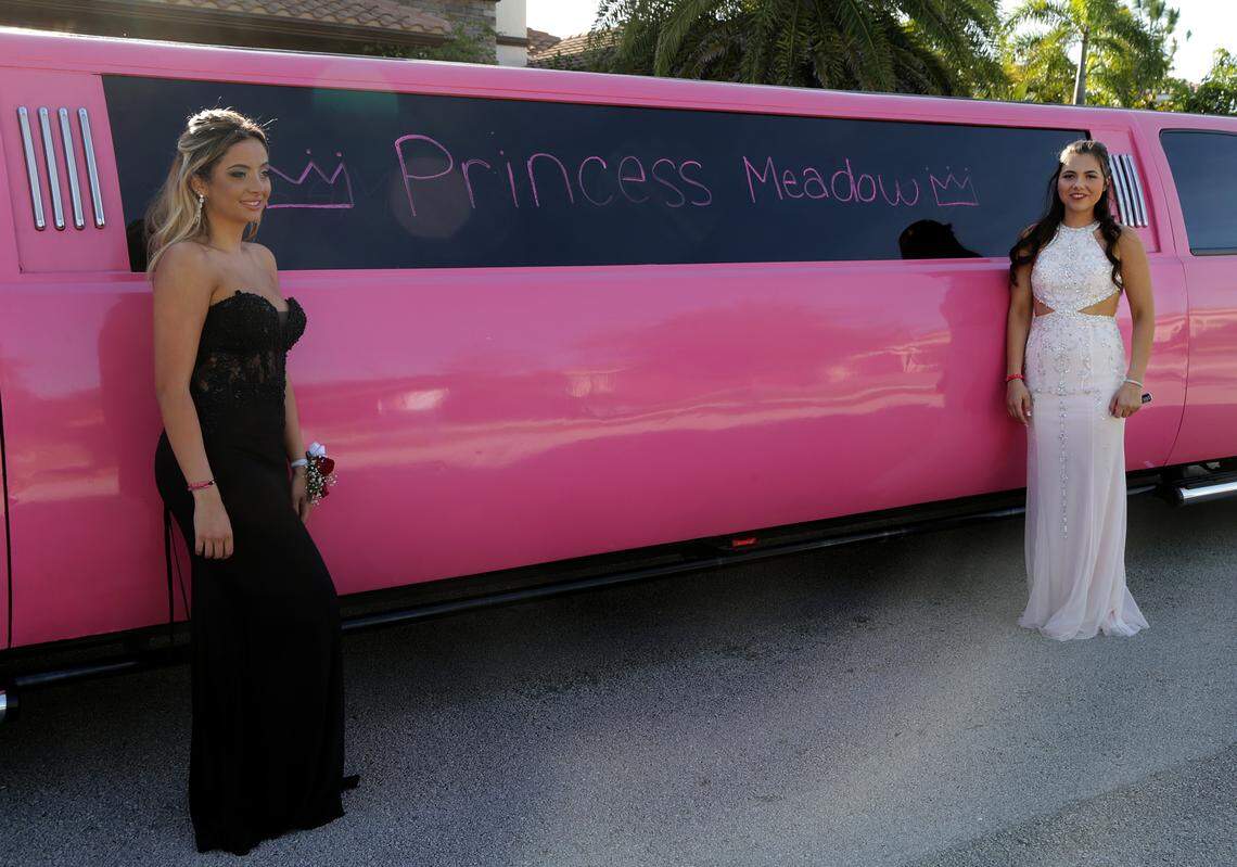 Nicolette Miciotta, left, and Carley Ogozaly pay tribute to their best friend Meadow Pollack writing her name and messages on a pink (Meadow's favorite color) limousine as they get ready to go to the prom Saturday, May 5, 2018. Meadow was one of four seniors killed in the mass shooting at Marjory Stoneman Douglas High School in Parkland, in which 17 students and educators were killed.