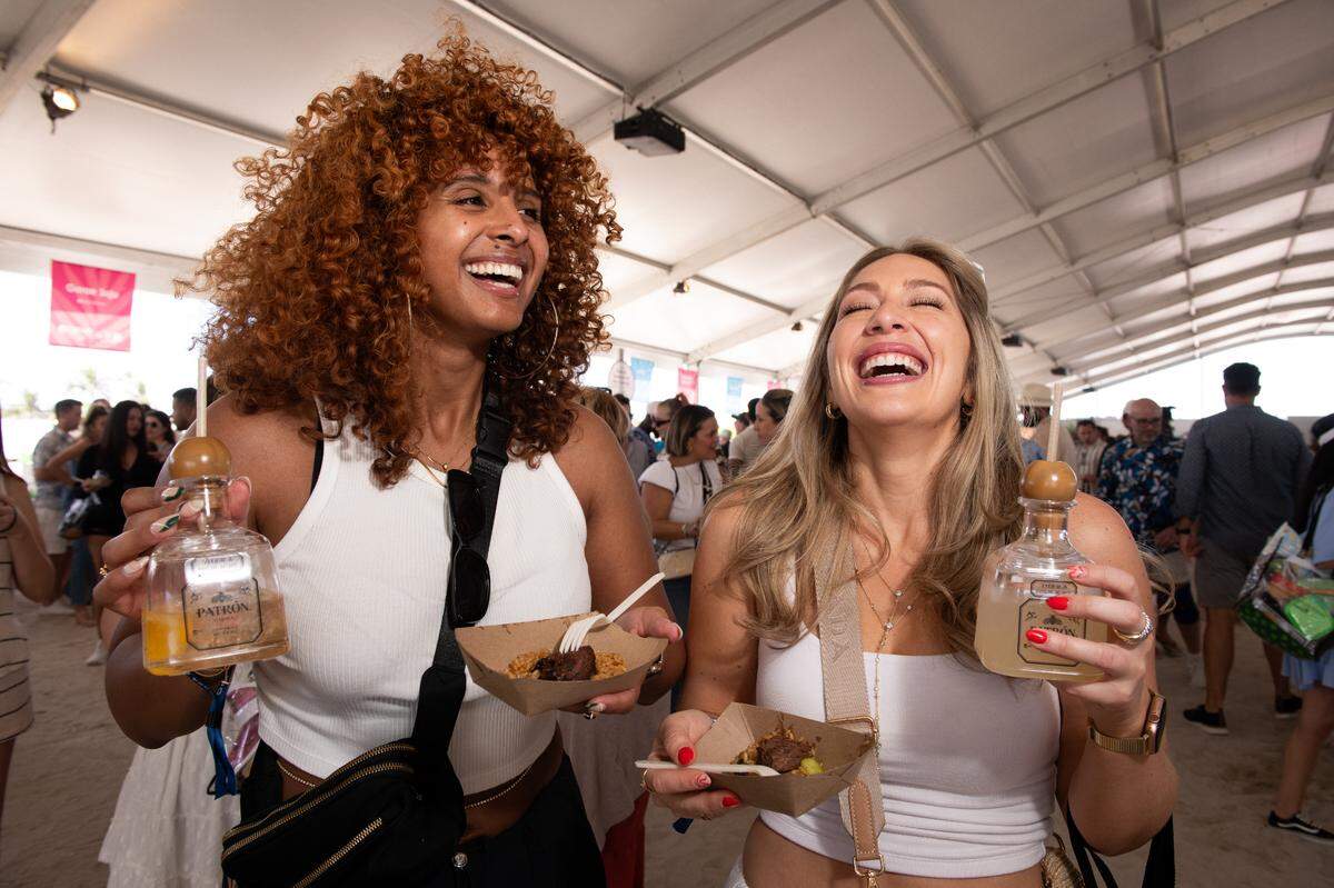 Guests sample food and drink at the Grand Tasting Village at the South Beach Wine & Food Festival on Miami Beach.