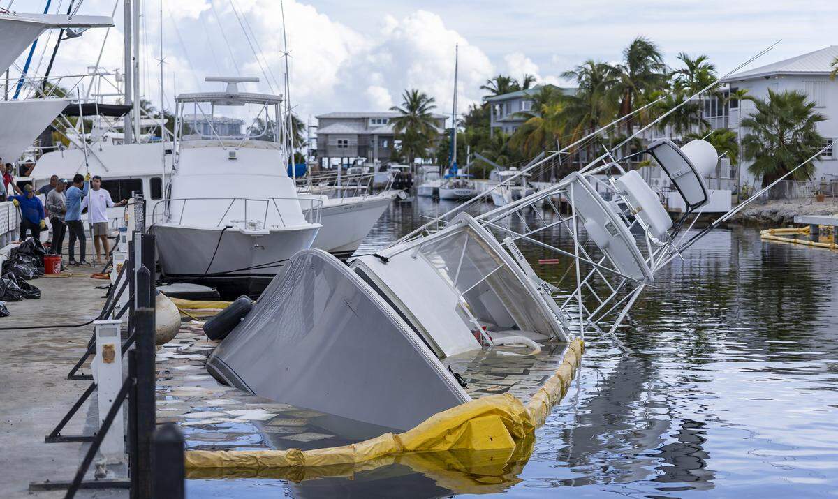 A view of a 55-foot yacht that is leaking diesel and is partially submerged at Key Largo Harbor Marina on Wednesday, Dec. 10, 2025, in Key Largo, Fla.