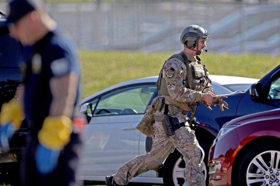 A law enforcement officer rushes toward Marjory Stoneman Douglas High School in Parkland after reports of an active shooter on Wednesday, Feb. 14, 2018.