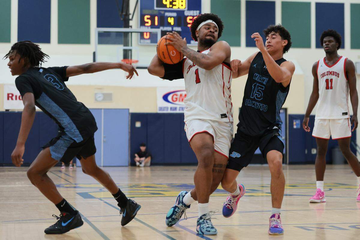 Columbus Explorers guard Cello Jackson (1) drives to the basket against Palmetto Panthers guard Darren Ku (15) during the fourth quarter of a Greater Miami Athletic Conference boys basketball finals game at Ronald W. Reagan Doral Senior High School on Saturday, Jan. 24, 2026, in Doral, Fla.