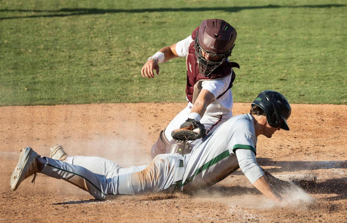 Stoneman Douglas Eagles catcher Drew Freeman (9) tags out Jupiter Warriors pitcher Gabe Graulau (8) out at home plate in the third inning of their Class 7A state baseball championship game at Hammond Stadium on Saturday, May 17, 2025, in Fort Myers, Fla.