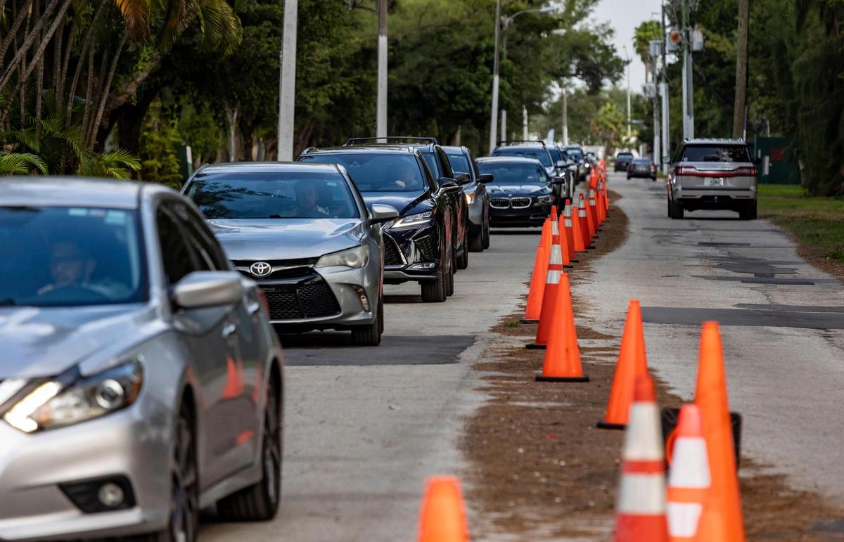 A long line of cars make their way towards the COVID-19 testing site at Miami’s Tropical Park on Dec. 21, 2021.