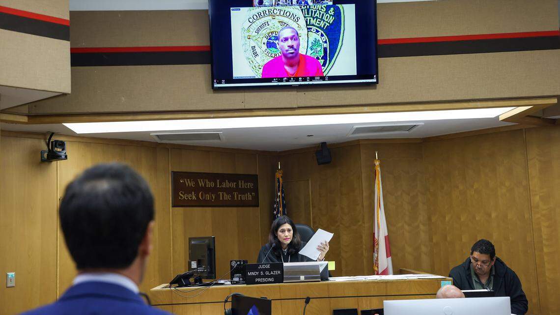 Antonio Brown, on the screen, appears for his bond hearing via Zoom requesting bail after his attorney, Mark Eiglarsh, right, filed a written plea of “not guilty” to the attempted murder charge in Bond Court (Courtroom 1-5) with Judge Mindy S. Glazer, center, presiding at the Richard E. Gerstein Justice Building on Wednesday, November 12, 2025, in Miami, Florida.