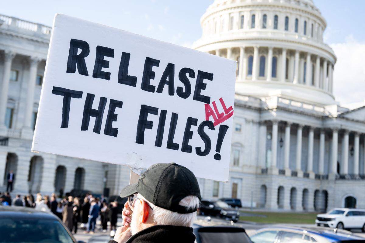 A protester holds a sign related to the release of the Jeffrey Epstein case files outside the US Capitol in Washington, DC, November 12, 2025.