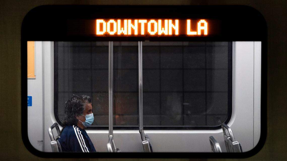 In this stock photo, a commuter sits in a Los Angeles Metro train in Los Angeles, Wednesday, July 13, 2022.