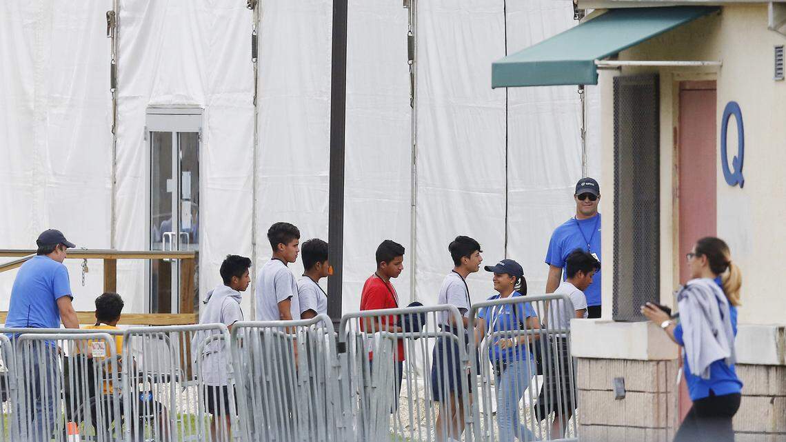 Immigrant children walk in a line on June 20, 2018, outside the Homestead Temporary Shelter for Unaccompanied Children, a former Job Corps site that now houses them in Homestead.  The Trump Administration said it would return more than 50 children to their parents on Tuesday. The children were separated from their parents when they crossed the border.