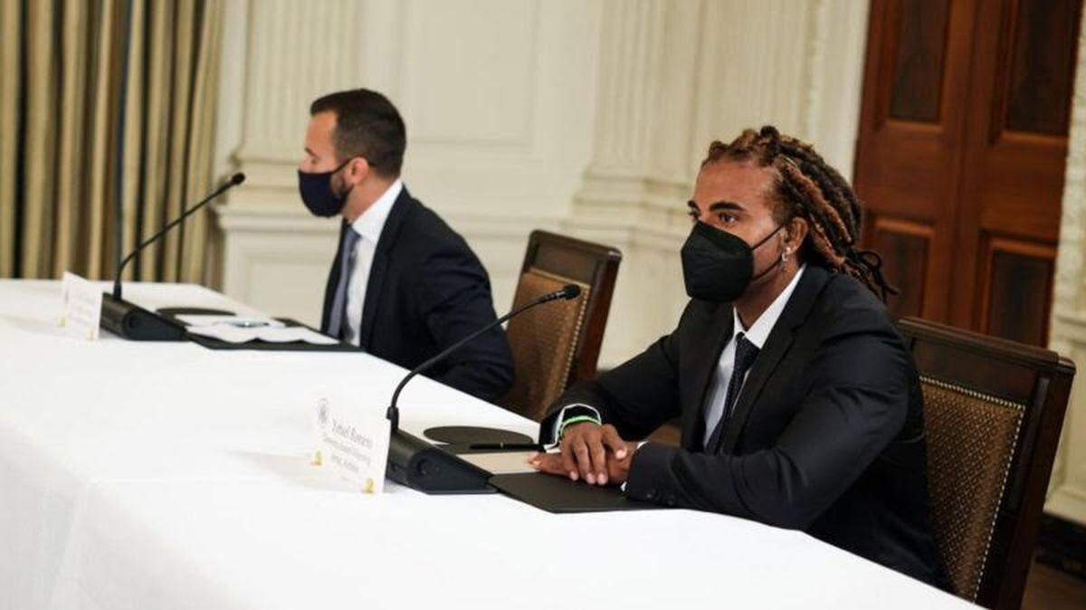Singer-songwriter Yotuel, right, and Felice Gorordo address group assembled by President Biden at the White House.