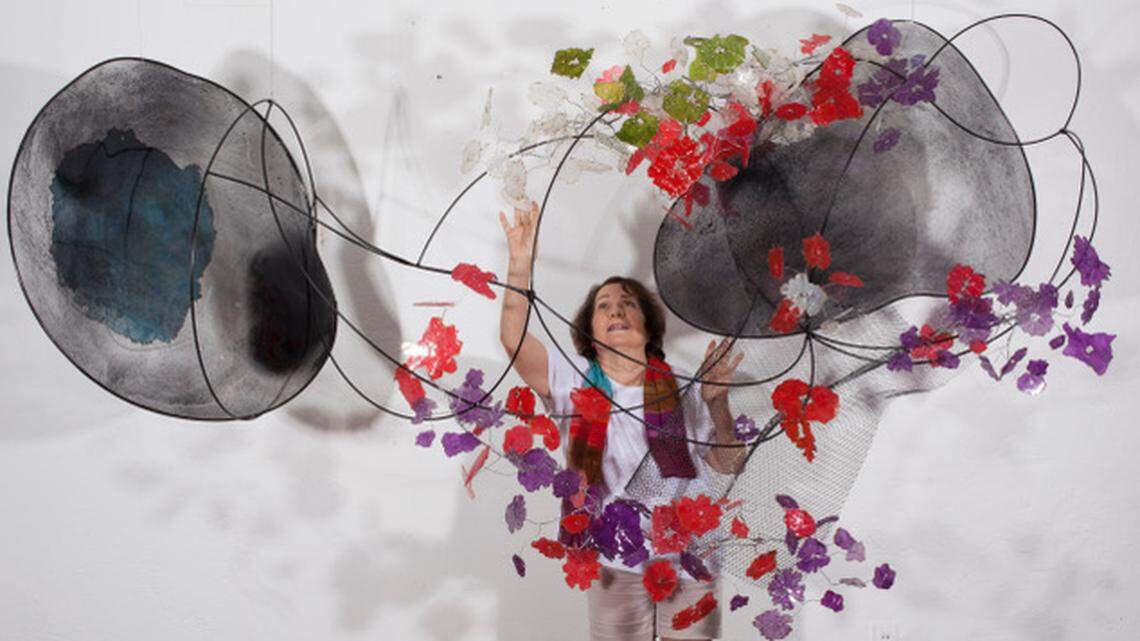 Eco-feminist artist Mira Lehr of Miami Beach has been painting and sculpting for more than 60 years. Here she is with her “Coriolis” sculpture in 2017. 
